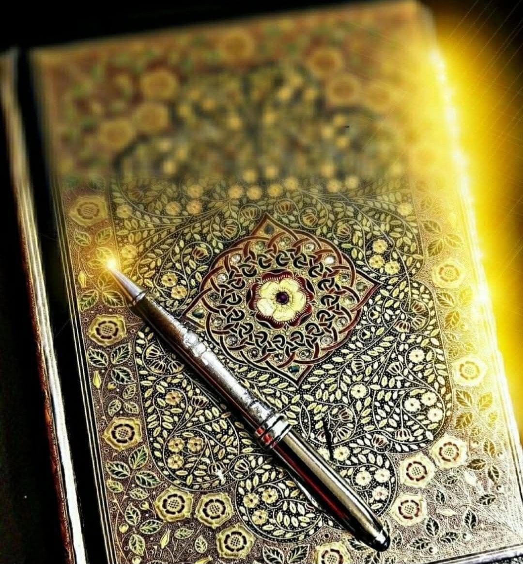 An ornate journal with gold filigree cover, a decorative silver fountain pen, and a yellow sunflare on a black background,...